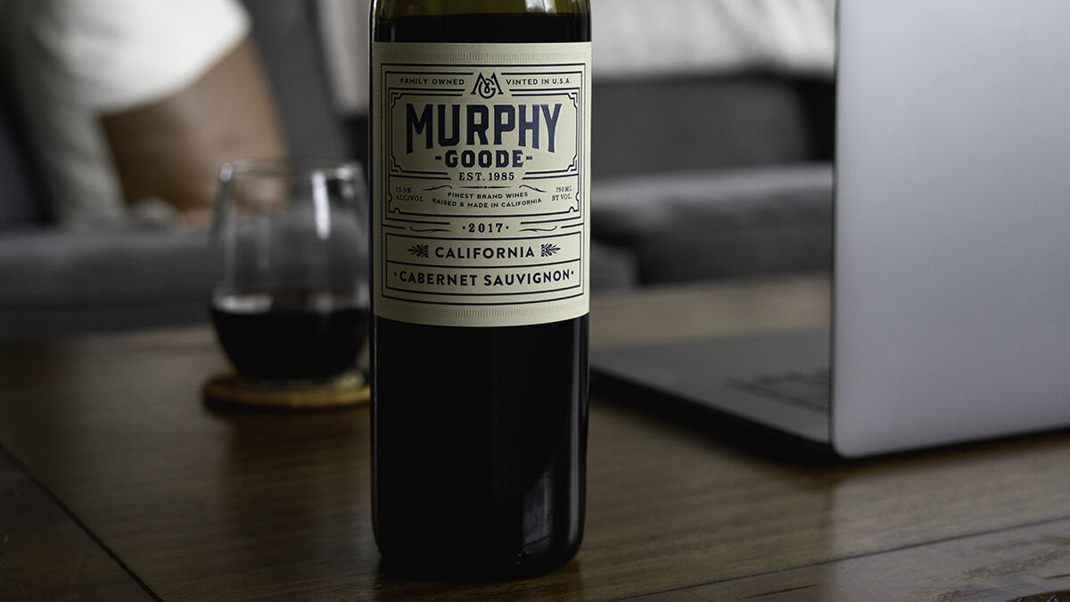 Murphy-Goode wine bottle on a table with a laptop